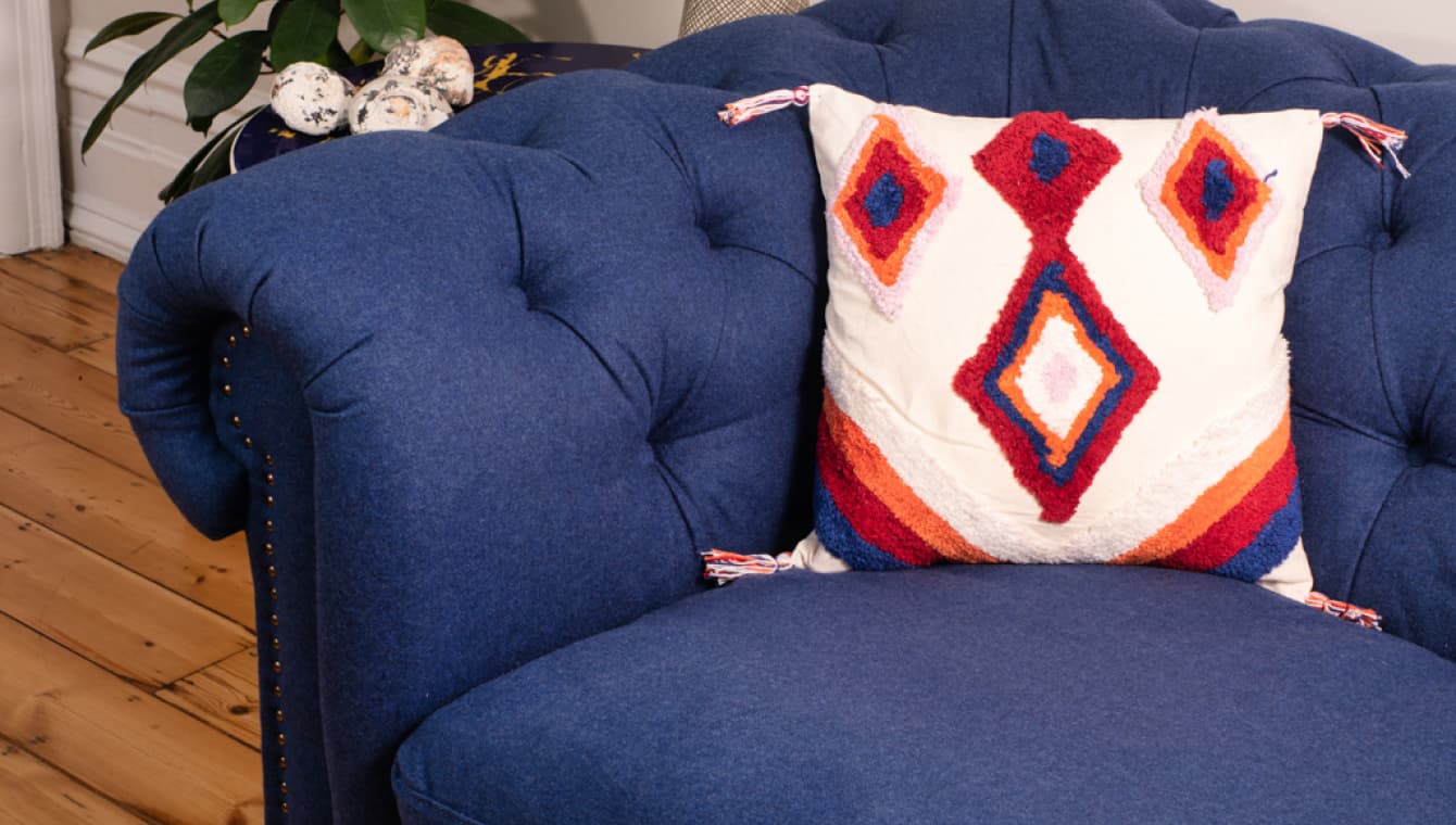 Cushion cover on blue sofa