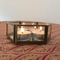 This glass jar with mirror base has a hexagonal metal frame and is suitable as candle holder or decorative display box.