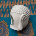 Oil warmer white in Buddha head shape shown from back