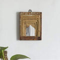 Small wood frame mirror hanging on wall