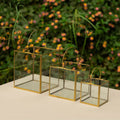 Set of 3 golden frame lantern candle holders on taple top